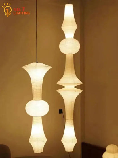 Two elegant off-white akari noguchi vintage pendant lights with geometric paper shades hang from the ceiling
