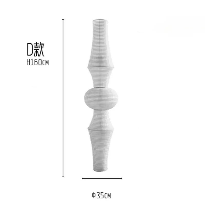 A tall white paper pendant light with fluted sections and rounded midpoints from decorbites akari noguchi vintage collection