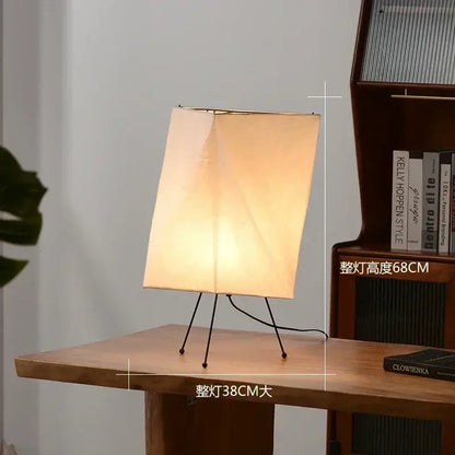 DecorBites Akari rice paper floor lamp with warm-toned rectangular shade and minimalist black metal tripod base