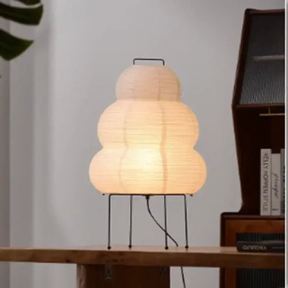 DecorBites Akari rice paper floor lamp with warmly glowing tiered shade and minimalist black metal stand for home decor