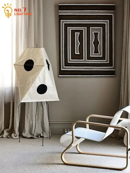 Cream-colored akari rice paper floor light with black circular accents and minimalist metal stand vintage style