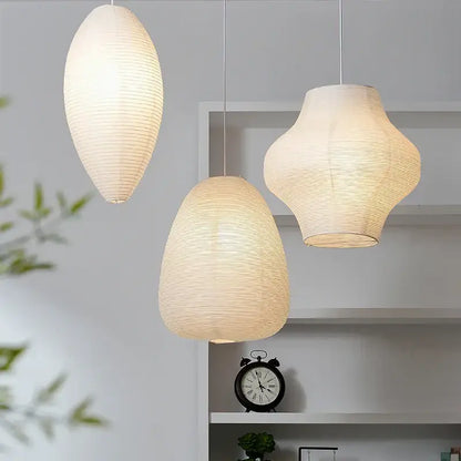 Three elegant off-white akari rice paper pendant lamps with ribbed texture and soft glow for living room and bedroom decor