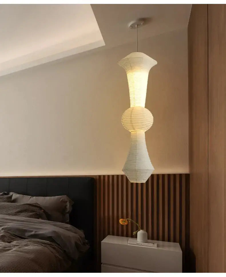 A modern white tiered sculptural pendant light made of akari rice paper for living room and bedroom decor