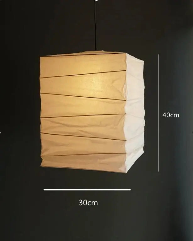 A warm-toned akari rice paper pendant lamp with segmented design and fold lines for living room bedroom lighting