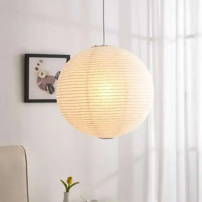 Warmly glowing white akari rice paper pendant light handwoven spherical paper lantern for home décor by decorbites
