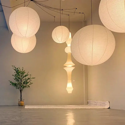 White ribbed rice paper pendant light akari vintage rice by DecorBites gently hangs emitting soft warm light