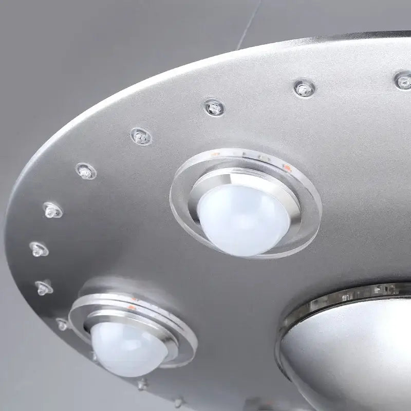 Silver alien ufo design iron art chandelier with three frosted globe bulbs and metallic rim for children’s room