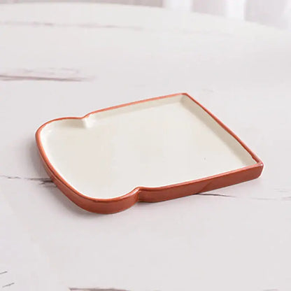 A ceramic toast-shaped alkali water biscuit tray with matte terracotta rim and white interior for biscuit mug ceramic use