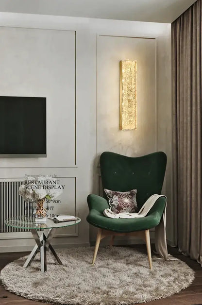 Emerald green velvet armchair with wooden legs and patterned cushion beside decorbites™ all copper wall lamp for light luxury