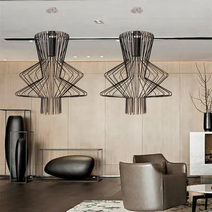 Two black wireframe geometric tiered allegro ritmico chandeliers hang from the ceiling in a vintage industrial style
