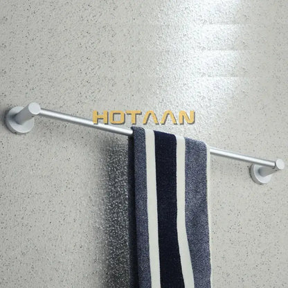 Silver metallic aluminium towel bar rail holder with sleek modern design holding navy white striped towel