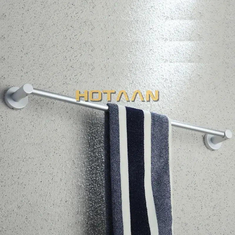 Silver metallic aluminium towel bar rail holder with sleek modern design holding navy white striped towel