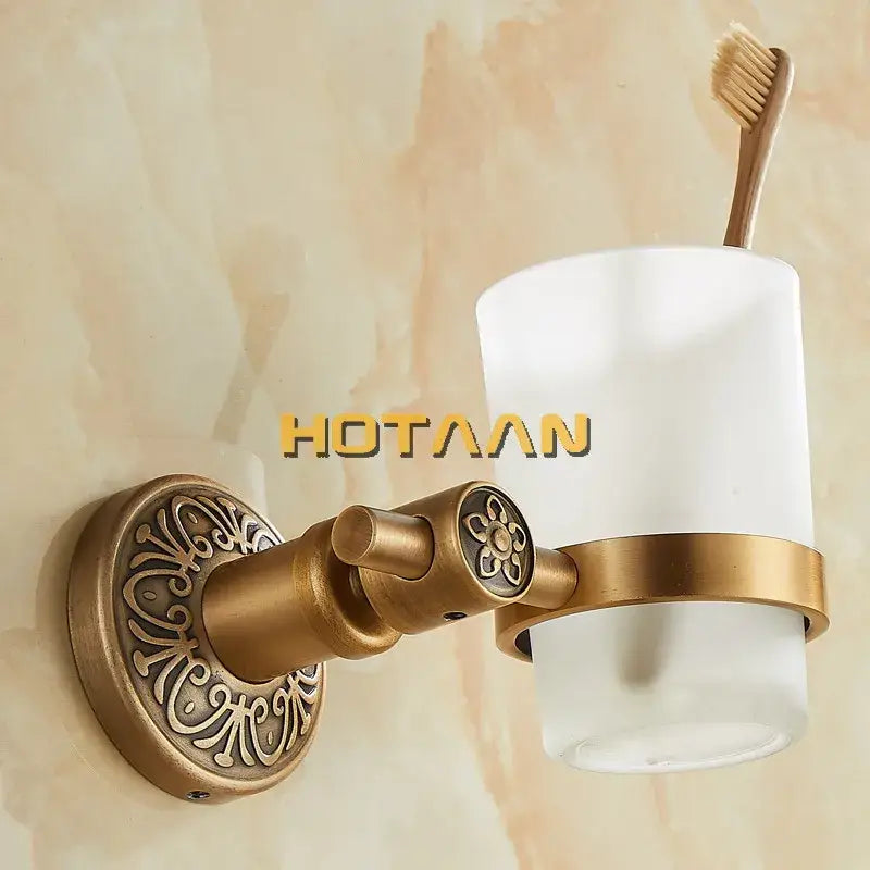 DecorBites aluminium single tumbler holder with antique brass finish and frosted white glass cup for cup holder use