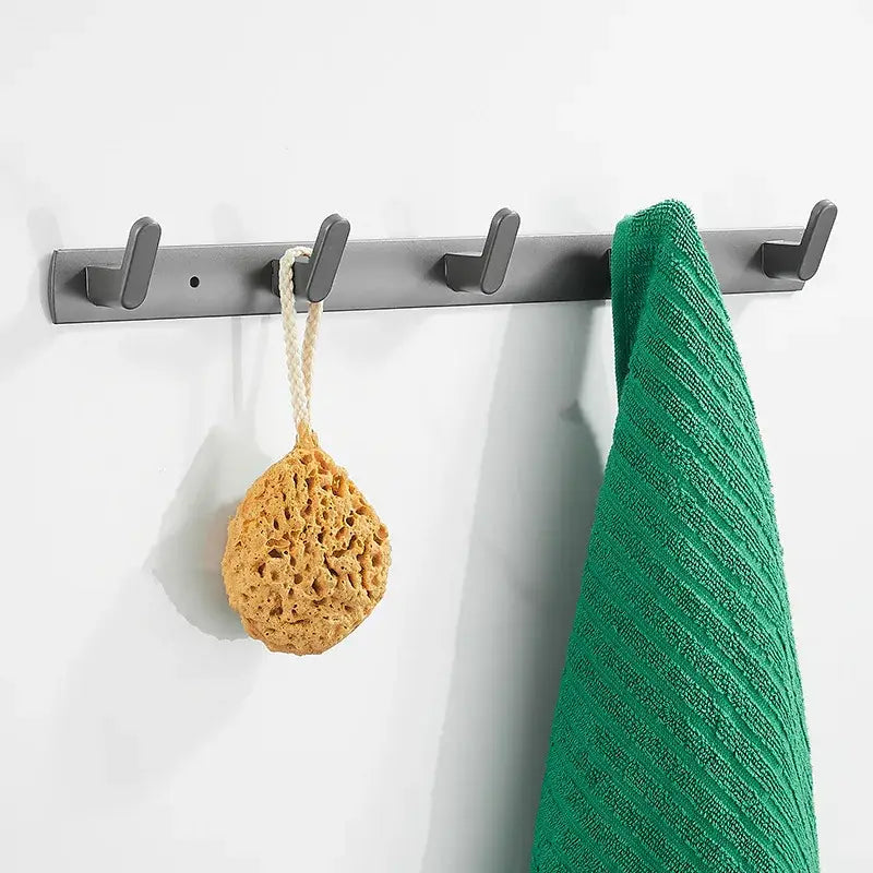 Gray aluminum alloy towel hooks wall mounted rack with five hooks holding green towel and beige loofah sponge