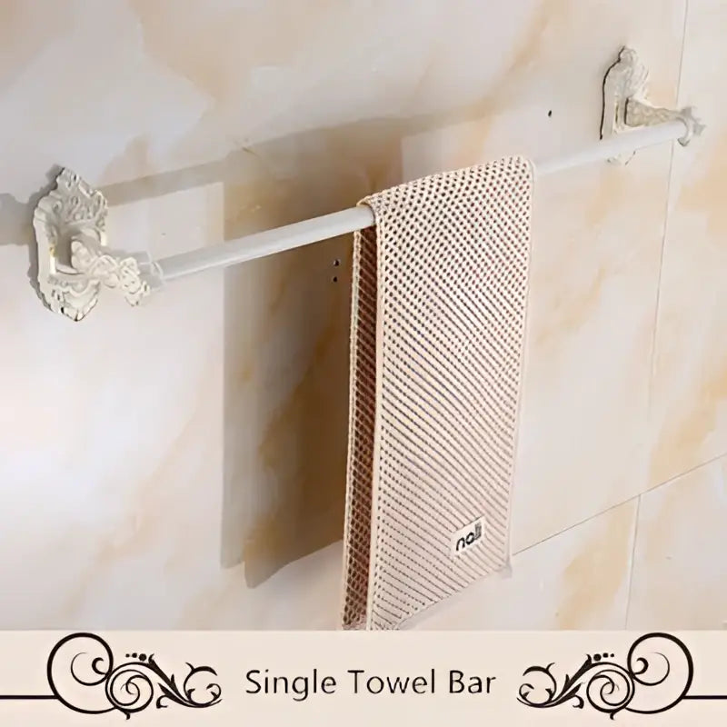 Antique white ornate aluminum towel bar with textured beige towel from decorbites bath hardware set