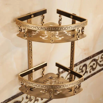 Brass double-tier corner shelf with ornate scrollwork and black trim ideal as a bathroom corner shelf for shower rooms