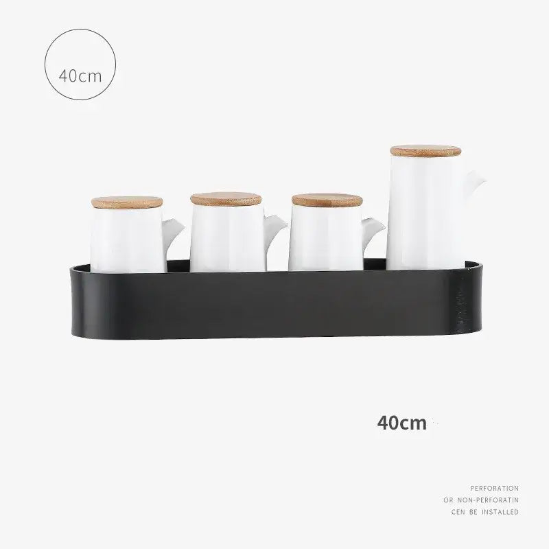Set of four white ceramic pitchers with bamboo lids on a black tray on decorbites aluminum bathroom shelf with towel bar