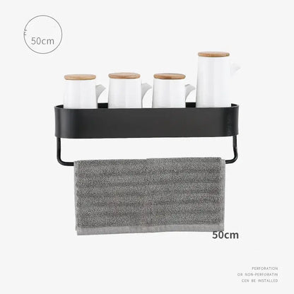 Decorbites aluminum bathroom shelf with towel bar in black metal holds four white mugs with wooden lids and a gray towel