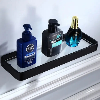 Black glass corner shelf with sleek aluminum frame holding three grooming products in decorbites bathroom hardware set