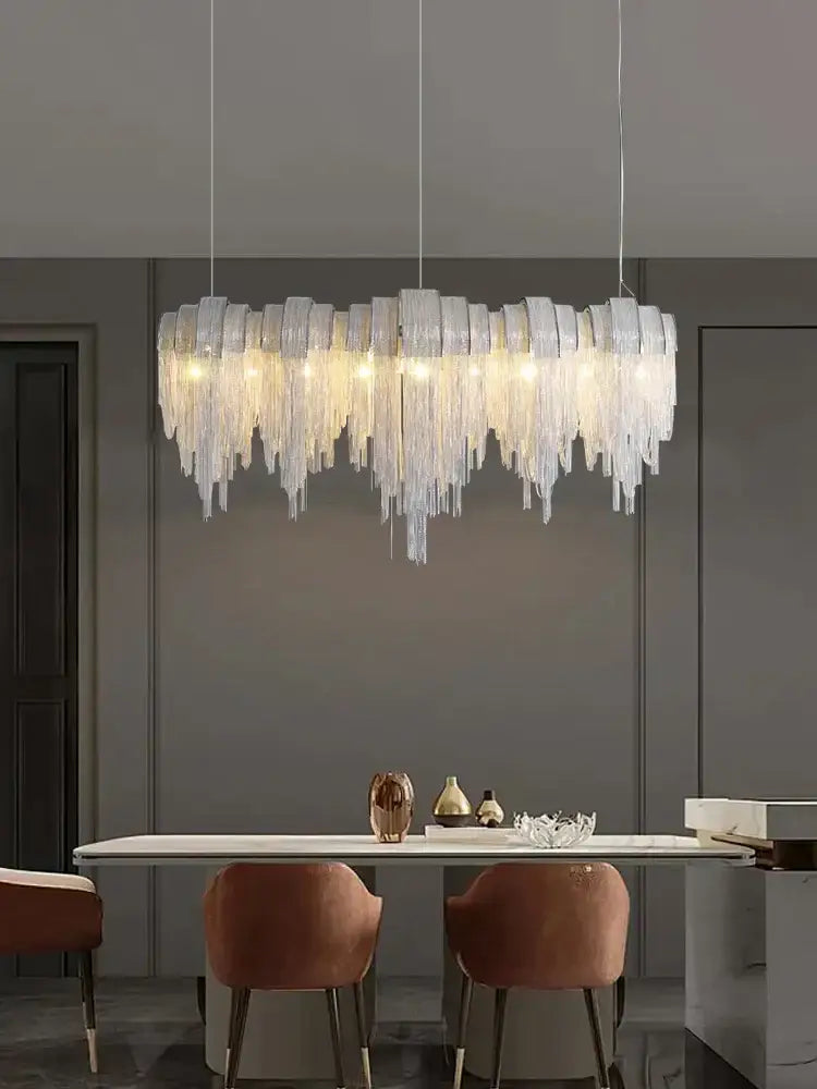 A modern aluminum chain pendant light with cascading frosted glass prisms for dining table illumination