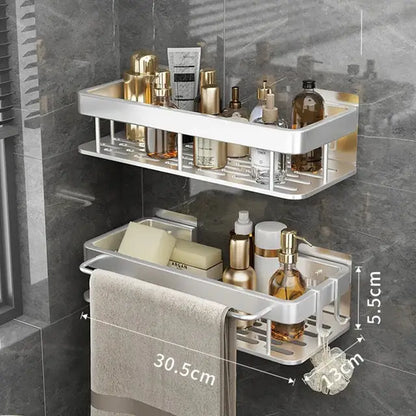 Silver aluminum double-tier corner shower storage rack with towel rack holding toiletries and beige towel