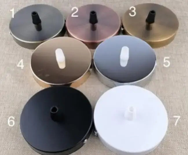 Seven circular DecorBites™ aluminum vintage lamp base holders in black bronze copper and white metallic finishes