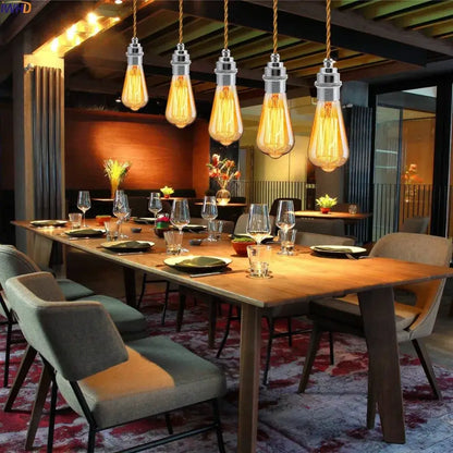 Five vintage-style edison bulb pendant lights with warm amber glass and chrome lamp base holders on twisted copper cords