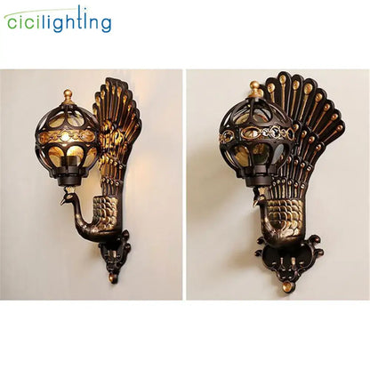 DecorBites aluminum globe glass wall lamp featuring antique bronze gold peacock sconce with ornate feather details