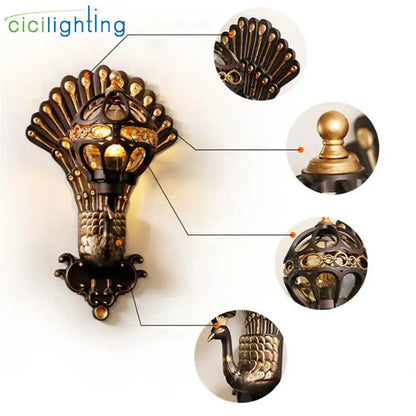 Antique bronze and gold-toned peacock-themed wall lamp with aluminum globe glass and intricate filigree detailing