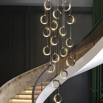 Modern minimalist aluminum led chandelier with polished metallic rings emitting warm ambient light for luxury staircases