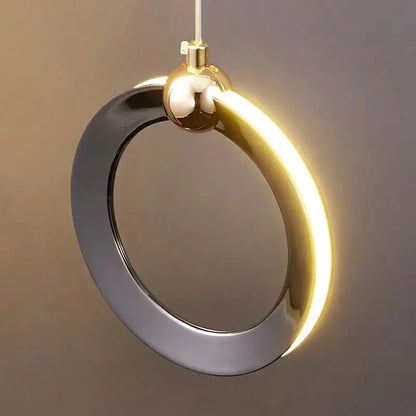 A sleek decorbites aluminum led chandelier with polished gold and matte black rings and integrated glowing led strip