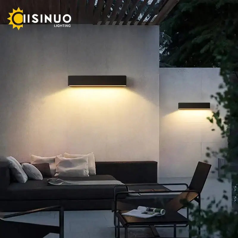 Decorbites™ modern black aluminum outdoor wall sconces emitting warm yellow light for house patio and garage lighting