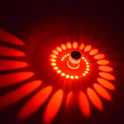A sleek decorbites aluminum spiral wall lamp with metallic finish casting warm spiral illumination for living rooms