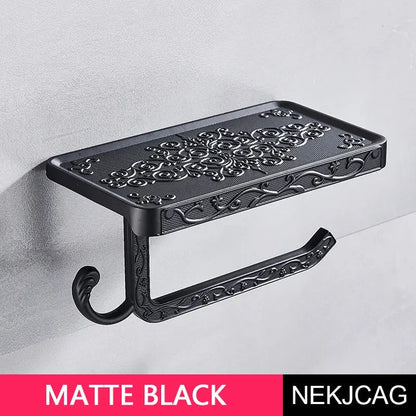 Matte black ornate aluminum toilet paper holder with intricate floral scrollwork and phone rack by decorbites