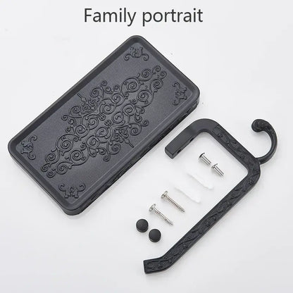 Black ornate aluminum toilet paper holder with phone rack and hook featuring intricate scrollwork design decorbites paper holder