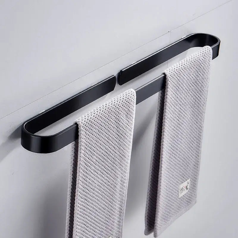 DecorBites aluminum towel holder matte black wall mounted towel bar with black matte finish holding two gray towels