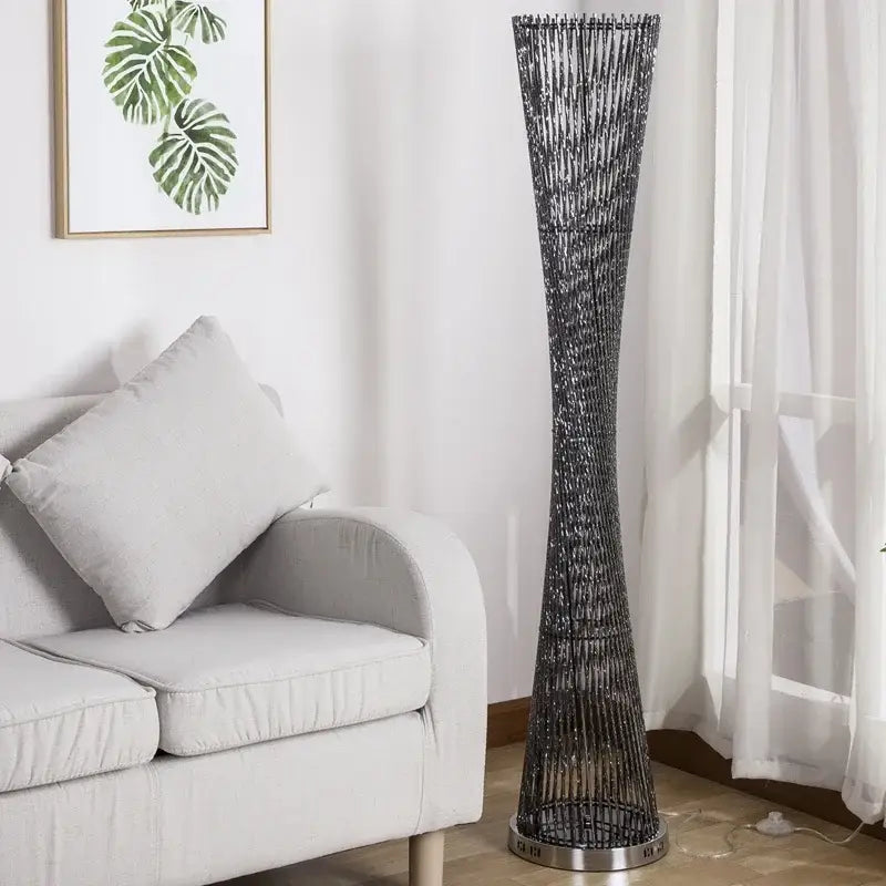 Tall slender floor lamp with dark metallic finish and intricate woven design by decorbites aluminum tower floor lamp