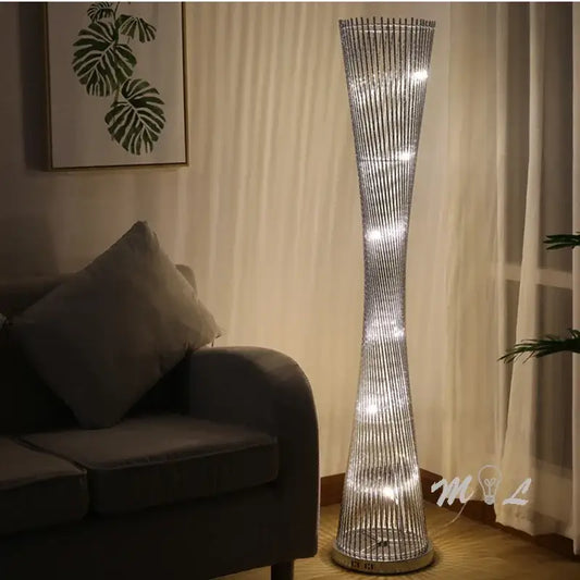 Modern silver aluminum tower floor lamp with twisted wireframe design and embedded led lights for living room use