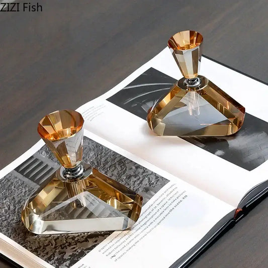 Two elegant faceted amber crystal perfume bottles with metallic silver caps for decorative aromatherapy use