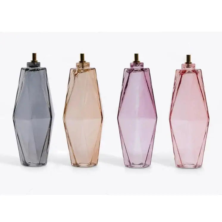 Four geometric glass perfume bottles in gradient gray amber lavender and rose pink complement DecorBites™ amber glass ceiling chandelier vintage style