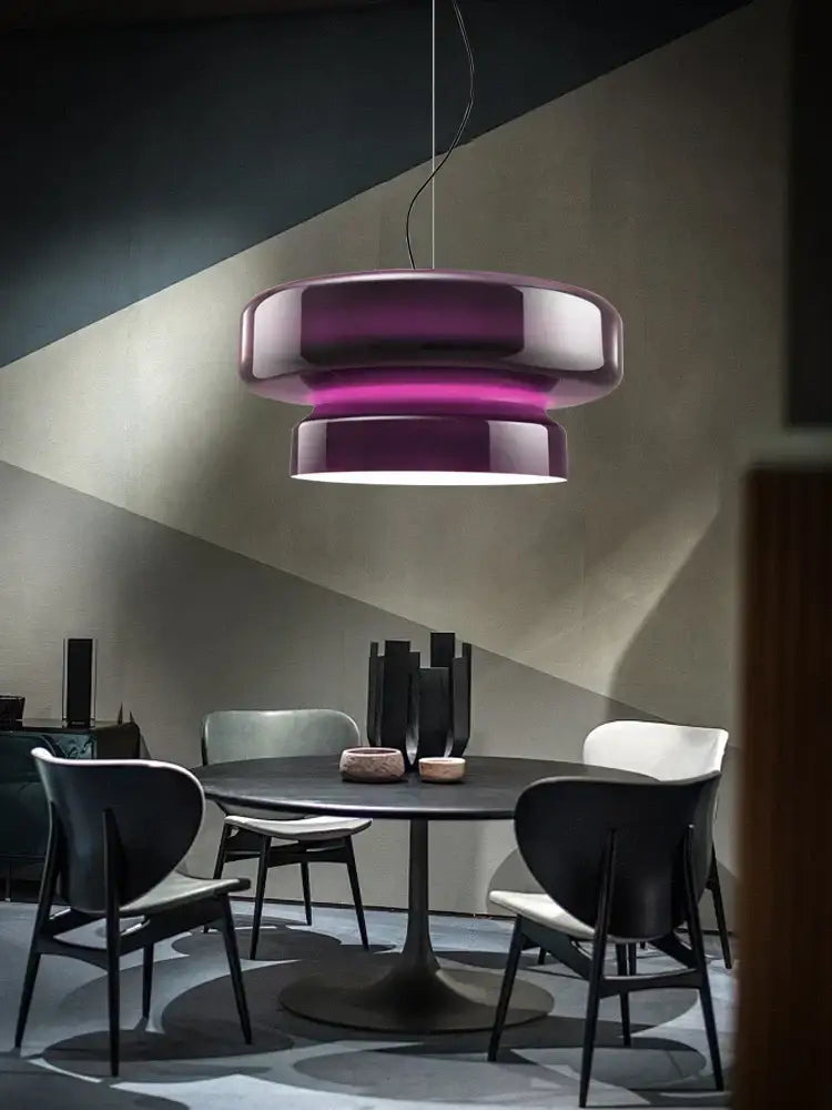 A sleek decorbites™ amber glass ceiling pendant light with a glossy purple and white gradient hanging above a dining table