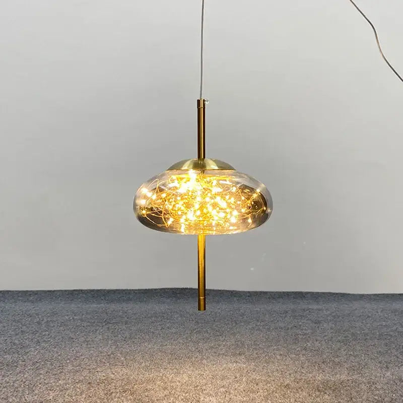 Decorbites amber glass chandelier with brass rod and translucent dome housing warm glowing string lights for luxury lighting