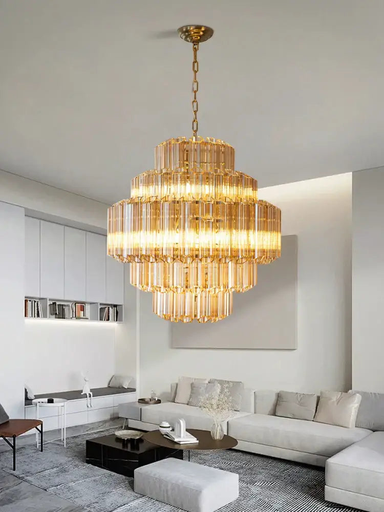 Golden tiered amber glass chandelier with cascading crystal rods suspended by brass chain for living and dining room