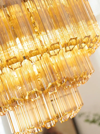 Golden tiered glass chandelier with cascading amber glass rods and intricate metal accents for living and dining rooms