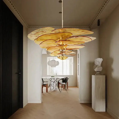 Golden layered amber glass chandelier with petal-like design for luxury vintage living space in duplex villa