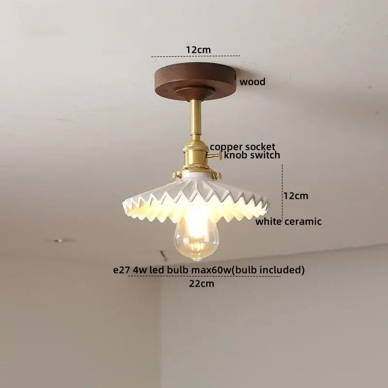 Vintage-style ceiling light fixture with dark wood base, brass copper socket, and white scalloped ceramic shade