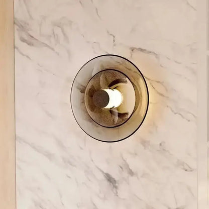 Decorbites amber glass disc wall lamp with a modern circular frosted glass disc shade and warm LED bulb lighting