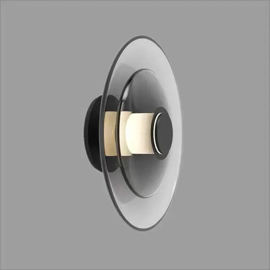 Modern black and frosted glass disc wall sconce with concentric circular design for minimalist wall lamp lighting