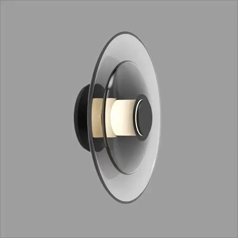 Modern black and frosted glass disc wall sconce with concentric circular design for minimalist wall lamp lighting