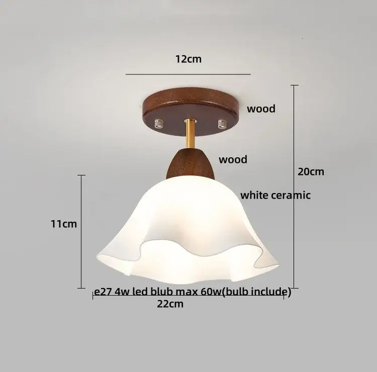 A white ceramic fluted lampshade on a wooden fixture and brass stem for decorbites amber glass led ceiling light